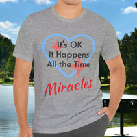 Soft, breathable Bella+Canvas t-shirt made from preshrunk cotton with “Miracles Happen” design message, “It’s OK. It Happens All the Time – Miracles,” inspirational shirt encouraging intimacy with God that produces everyday miracles, man wearing gray t-shirt
