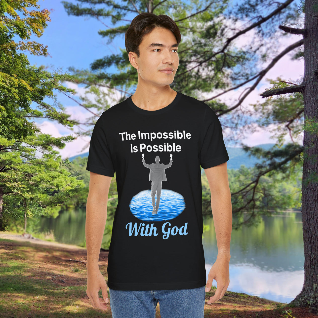 Soft, breathable Bella+Canvas t-shirt made from preshrunk cotton with “Impossible Man” design message, “The Impossible Is Possible with God,” inspirational shirt encouraging bold faith to step out and follow God into the impossible, man in black t-shirt at park