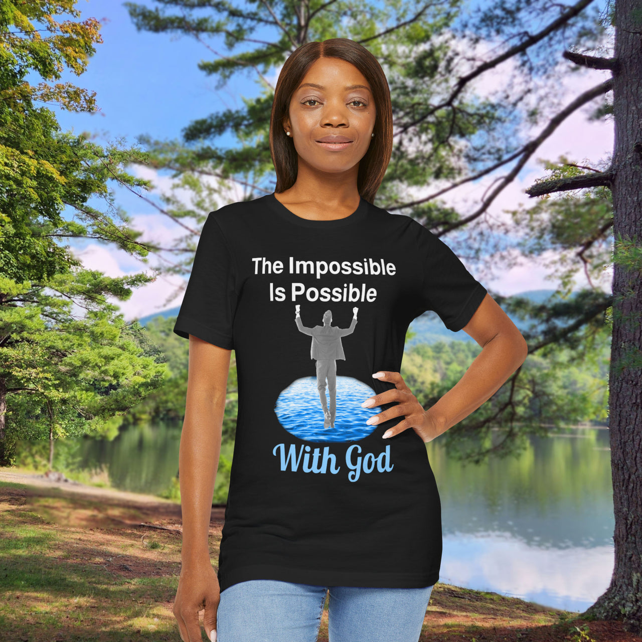Soft, breathable Bella+Canvas t-shirt made from preshrunk cotton with “Impossible Man” design message, “The Impossible Is Possible with God,” inspirational shirt encouraging bold faith to step out and follow God into the impossible, woman in black t-shirt at park
