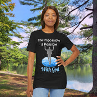 Soft, breathable Bella+Canvas t-shirt made from preshrunk cotton with “Impossible Man” design message, “The Impossible Is Possible with God,” inspirational shirt encouraging bold faith to step out and follow God into the impossible, woman in black t-shirt at park