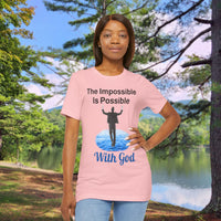 Soft, breathable Bella+Canvas t-shirt made from preshrunk cotton with “Impossible Man” design message, “The Impossible Is Possible with God,” inspirational shirt encouraging bold faith to step out and follow God into the impossible, woman in pink t-shirt at park