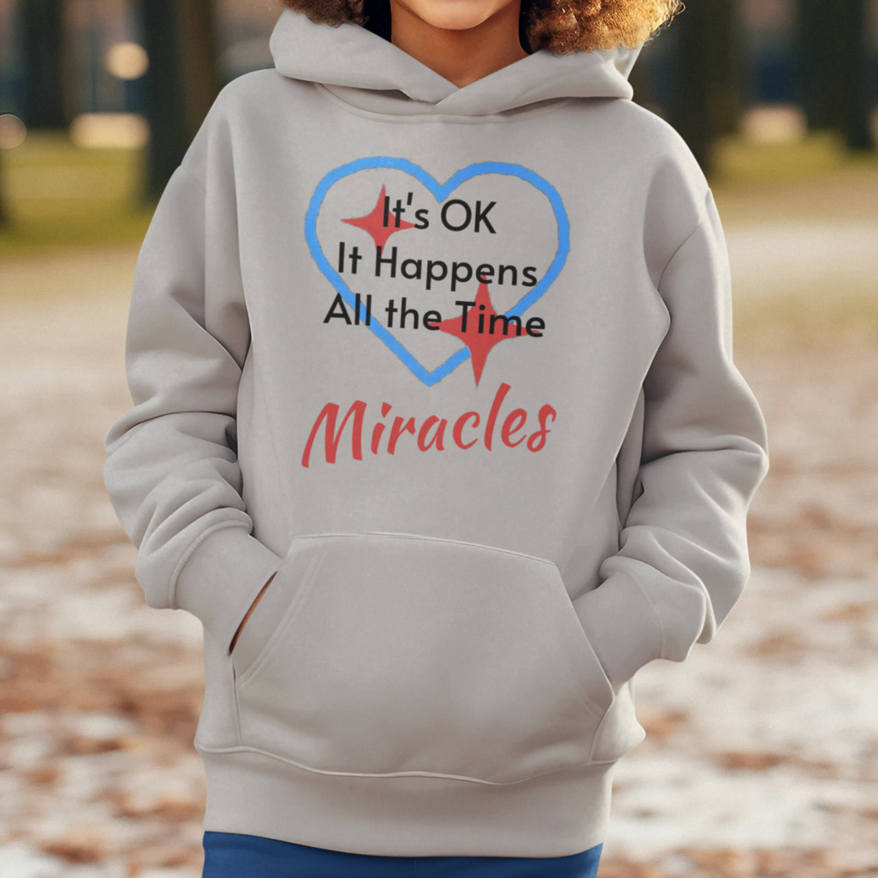 Gildan youth unisex hoodie with “Miracles Happen” design and uplifting message, Christian apparel made from soft preshrunk fleece, ideal for cooler weather and faith-inspired comfort, boy in gray hoodie