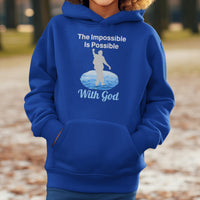Gildan youth unisex hoodie with “Impossible Teen” design featuring a teen walking on water and uplifting message, Christian apparel made from soft preshrunk fleece, perfect for cold weather and spiritual encouragement, boy in blue hoodie