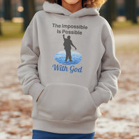 Gildan youth unisex hoodie with “Impossible Teen” design featuring a teen walking on water and uplifting message, Christian apparel made from soft preshrunk fleece, perfect for cold weather and spiritual encouragement, boy in gray hoodie