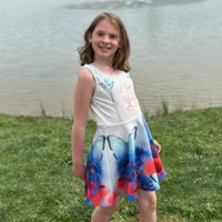 Blue girls’ sundress with butterfly and flower design, “I love you” message, part of Paisley’s Corner Collection, lightweight polyester-spandex blend, ideal for summer and special occasions, girl in butterfly sundress - right side