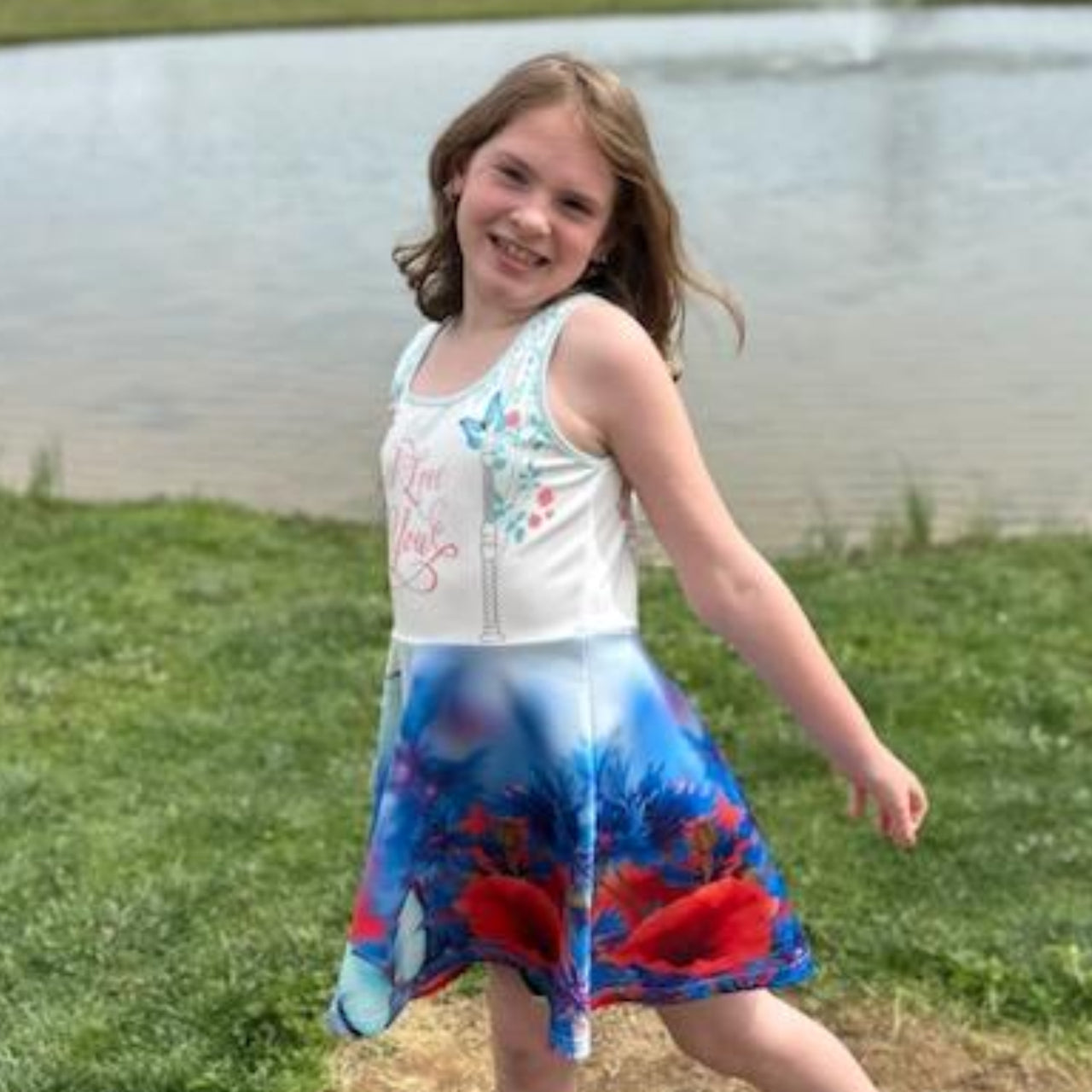Blue girls’ sundress with butterfly and flower design, “I love you” message, part of Paisley’s Corner Collection, lightweight polyester-spandex blend, ideal for summer and special occasions, girl in butterfly sundress