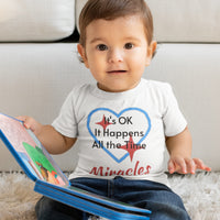 Bella+Canvas baby t-shirt with “Miracles Happen” design and uplifting message, soft cotton, breathable and durable, Christian apparel for infants and family matching, baby boy in white shirt