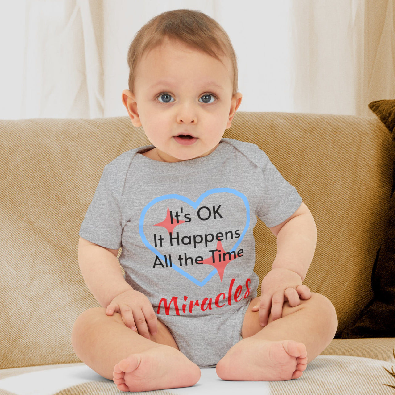 Bella+Canvas baby onesie with “Miracles Happen” design and uplifting message, soft cotton, envelope neck and snap closure, Christian apparel for infants and family matching, baby boy in gray onesie