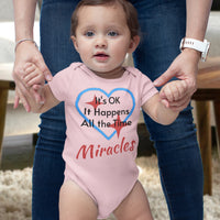 Bella+Canvas baby onesie with “Miracles Happen” design and uplifting message, soft cotton, envelope neck and snap closure, Christian apparel for infants and family matching, baby girl in pink onesie