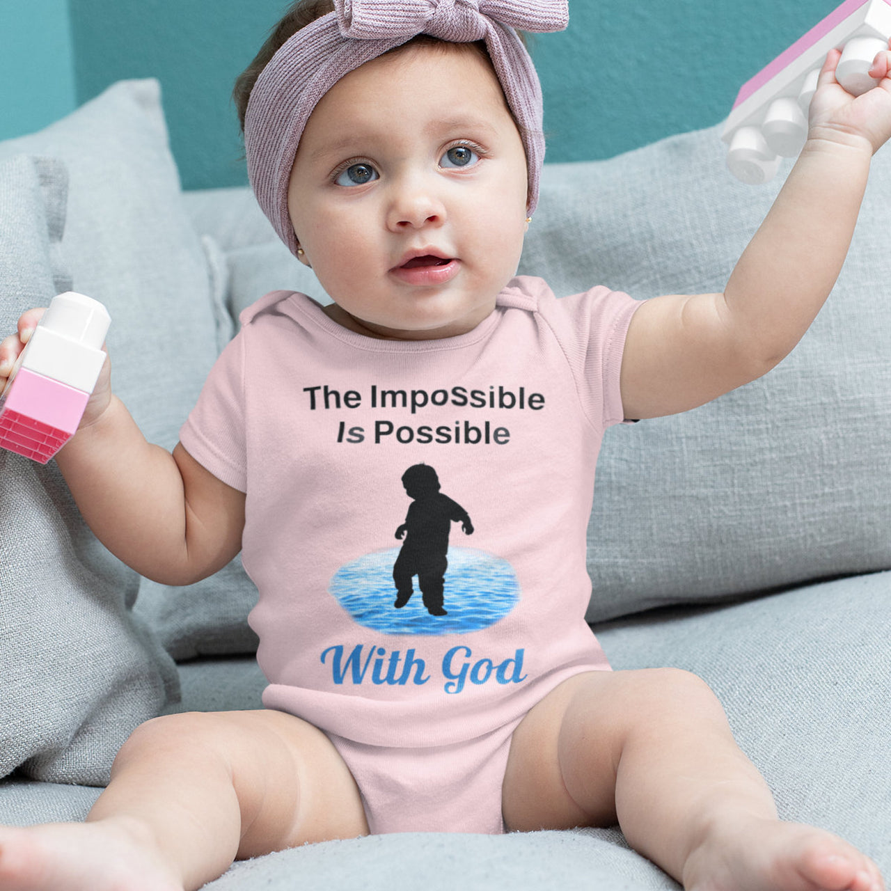 Bella+Canvas baby onesie with “Impossible Baby” design and faith-filled message, soft cotton, envelope neck and snap closure, Christian apparel for infants and spiritual encouragement, baby girl in pink onesie