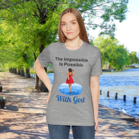 Soft, breathable Bella+Canvas t-shirt made from preshrunk cotton with “Impossible Woman” design message, “The Impossible Is Possible with God,” inspirational shirt encouraging bold obedience and faith-filled movement with God, woman in gray t-shirt at waterside walkway