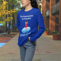 Long-sleeve Bella+Canvas t-shirt made from preshrunk ring-spun cotton with “Impossible Woman” design message, “The Impossible Is Possible with God,” inspirational apparel encouraging women to walk freely in God's incredible ways, woman downtown wearing blue long-sleeve t-shirt