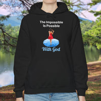 Gildan unisex hoodie with “Impossible Woman” design featuring a woman walking on water and uplifting message, Christian apparel made from soft cotton-poly blend, ideal for cold weather and faith-forward style, woman in black hoodie
