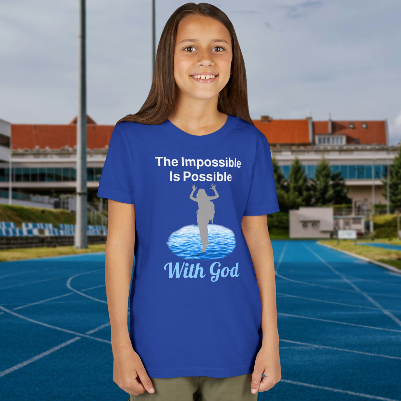 Bella+Canvas youth unisex t-shirt with “Impossible Girl” design featuring a girl walking on water and uplifting message, Christian apparel made from soft cotton, ideal for active wear and faith-forward style, 2nd girl in blue t-shirt