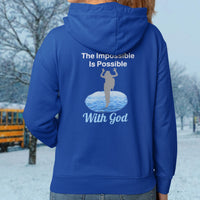 Gildan youth zip-up hoodie with “Impossible Girl” design featuring a girl walking on water and uplifting message, Christian apparel made from soft preshrunk fleece, ideal for cooler weather and faith-forward style, girl in blue hoodie