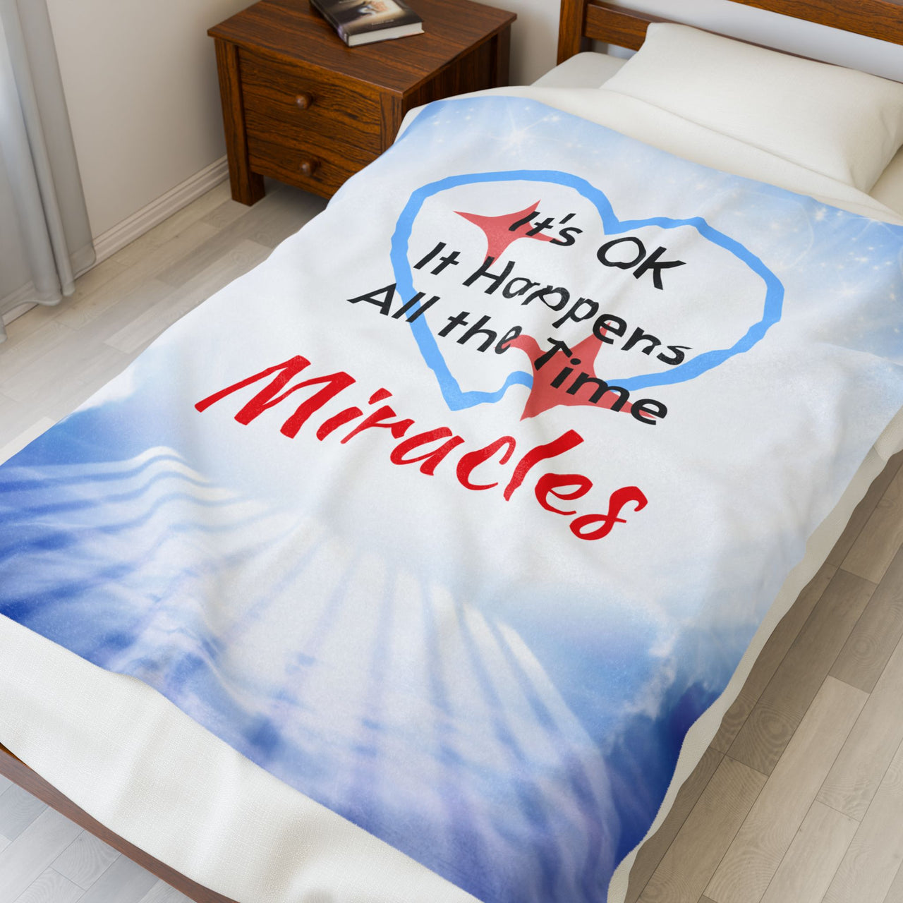 Inspirational plush blanket with “Miracles Happen” design and message "It's OK, It Happens All the Time - Miracles, soft velveteen fabric, faith-based home décor, full print front, white back, throw and twin sizes - throw size on bed