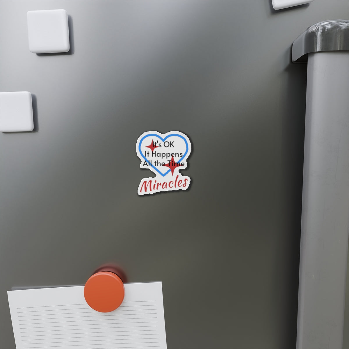 Vinyl die-cut magnet with "Miracles Happen" design, message “It’s OK. It Happens All the Time – Miracles,” durable matte finish, faith-based magnet for those desiring to encounter miracles often, 2-inch magnet on fridge