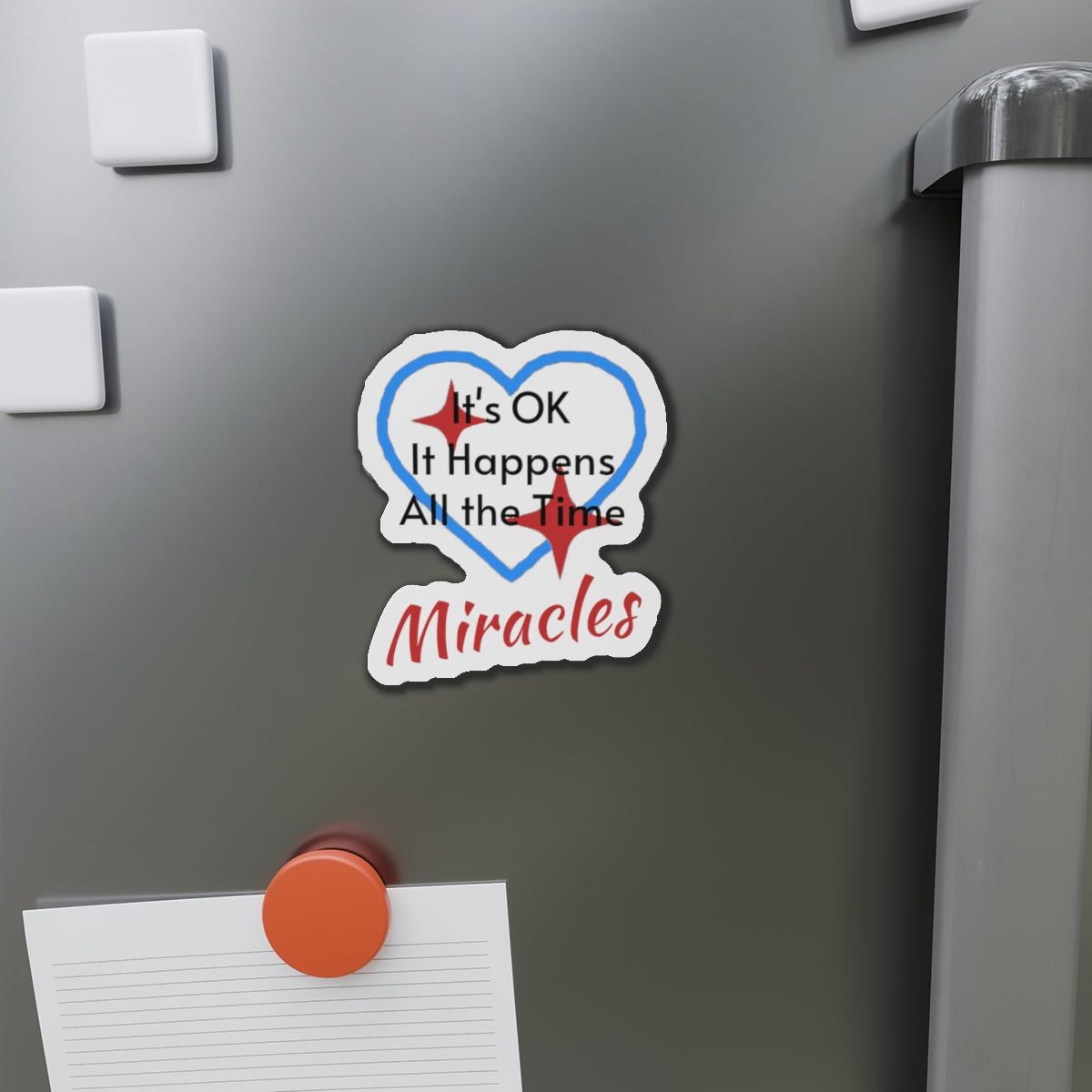 Vinyl die-cut magnet with "Miracles Happen" design, message “It’s OK. It Happens All the Time – Miracles,” durable matte finish, faith-based magnet for those desiring to encounter miracles often, 4-inch magnet on fridge